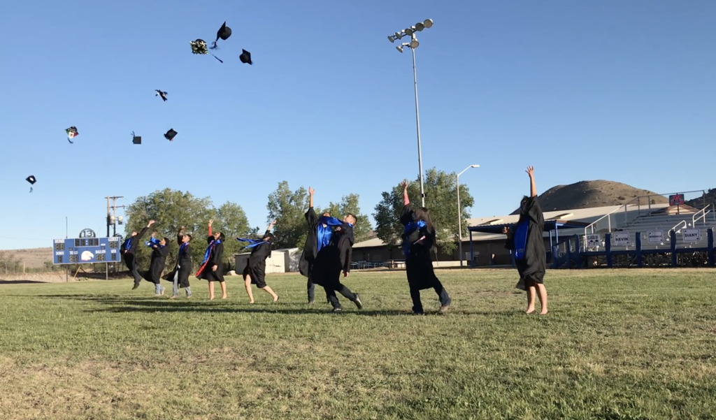 Hondo graduates throwing caps